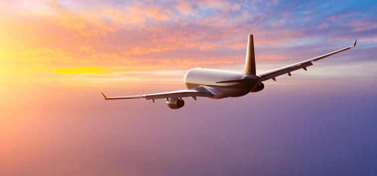 Airplane in flight at dusk